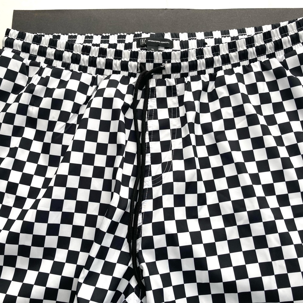 New I-N-C swimming/shorts in a black/white check pattern never worn